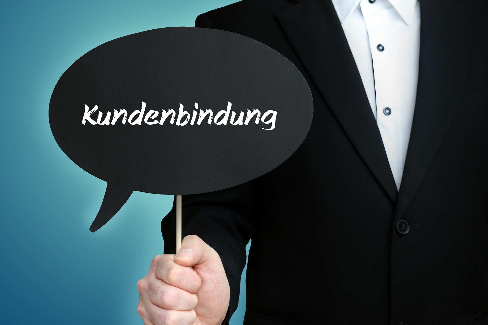 Schild mit dem Wort Kundenbindung in Hand gehalten | Geschenkkorb